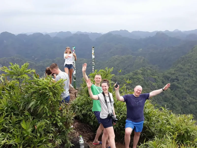 Hikers trekking through the Kim Giao forest on the way to Ngu Lam Peak, Cat Ba National Park.